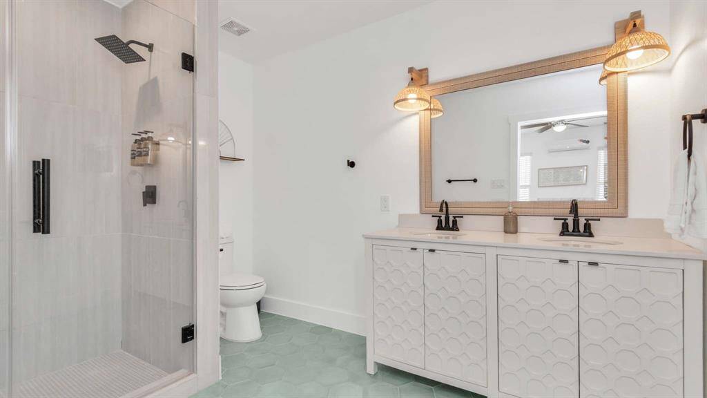 This ensuite is sure to make your guest feel like they are in a spa with the beautiful custom tile work, and double vanity.
