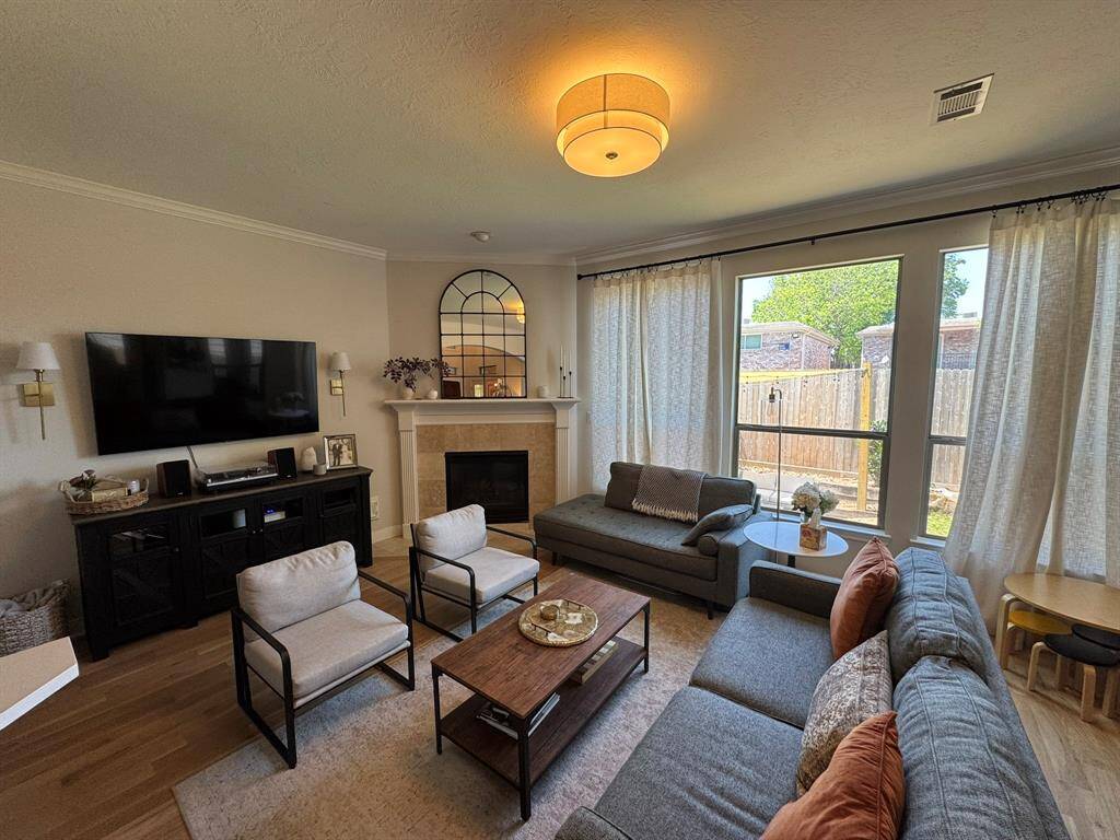 Living area with gas log fireplace open to kitchen and dining areas