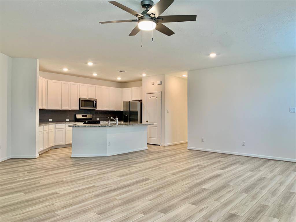 View of living room toward dining space and kitchen