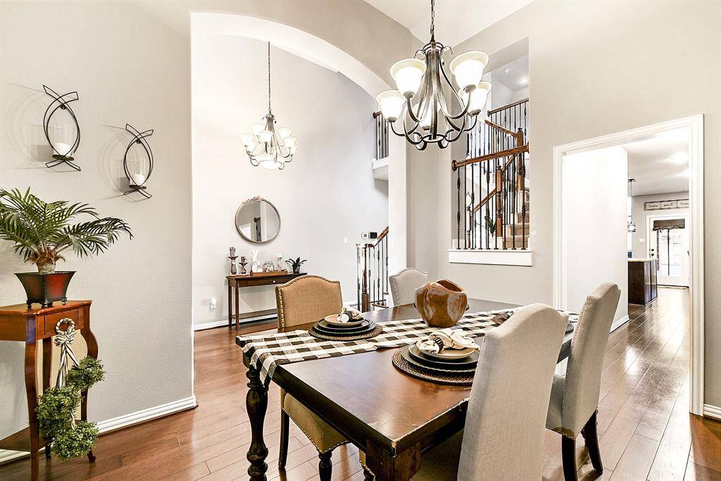 From the formal dining room, you have a clear view into the kitchen, creating a seamless connection between spaces. Just beyond, the breakfast room is beautifully framed, offering a cozy spot for casual meals. The layout also opens up toward the foyer, enhancing the home's open and welcoming feel.