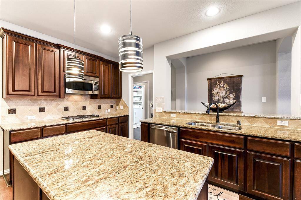 The heart of the home, this large and highly functional kitchen offers the perfect layout for everyday living and hosting. Featuring a center prep island and a second island with the kitchen sink that faces the open-concept living room, this space is ideal for staying connected with family or guests while you cook. With ample counter space.