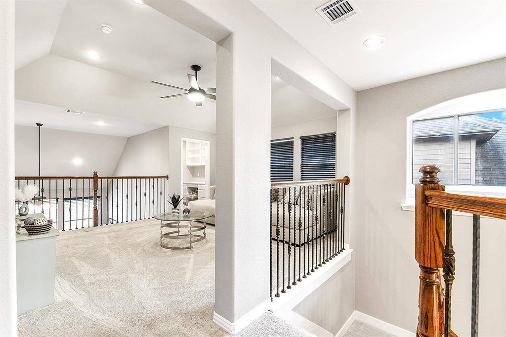 The upper level boasts a thoughtfully designed split floor plan, featuring two guest bedrooms with a hallway-style bathroom. It also includes a spacious game room and an additional study nook/office space. This layout is perfect for both privacy and functionality, offering a great balance of living and working areas.