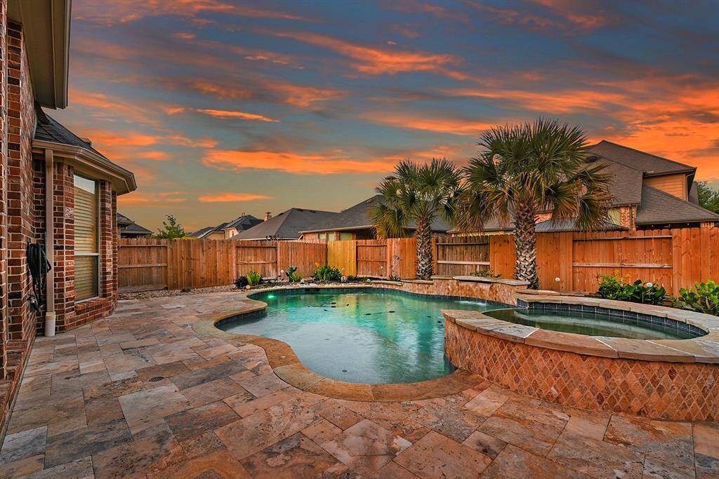 Enjoy plenty of extended patio space, perfect for relaxing on the sun deck in the private backyard. Surrounded by lush tropical landscaping, this outdoor space offers a peaceful and inviting atmosphere for soaking up the sun or entertaining in style.