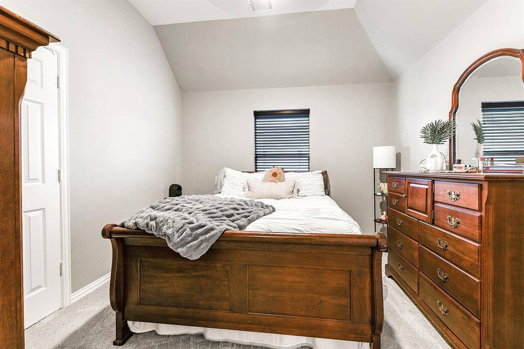 This upstairs guest bedroom is convenient attached to a Hollywood-style bathroom. The home features 4 bedrooms in total—2 upstairs and 2 downstairs—perfectly designed for flexible living and comfort.