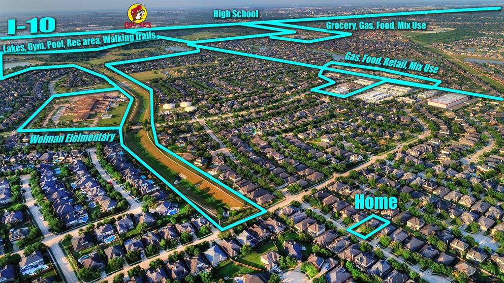 An aerial view highlights the home’s convenient proximity to the nearby elementary school, making school runs a breeze. It’s also just moments from I-10, offering quick access to major routes. Additionally, the neighborhood amenities and shopping centers are easily reachable, providing everything you need just around the corner.