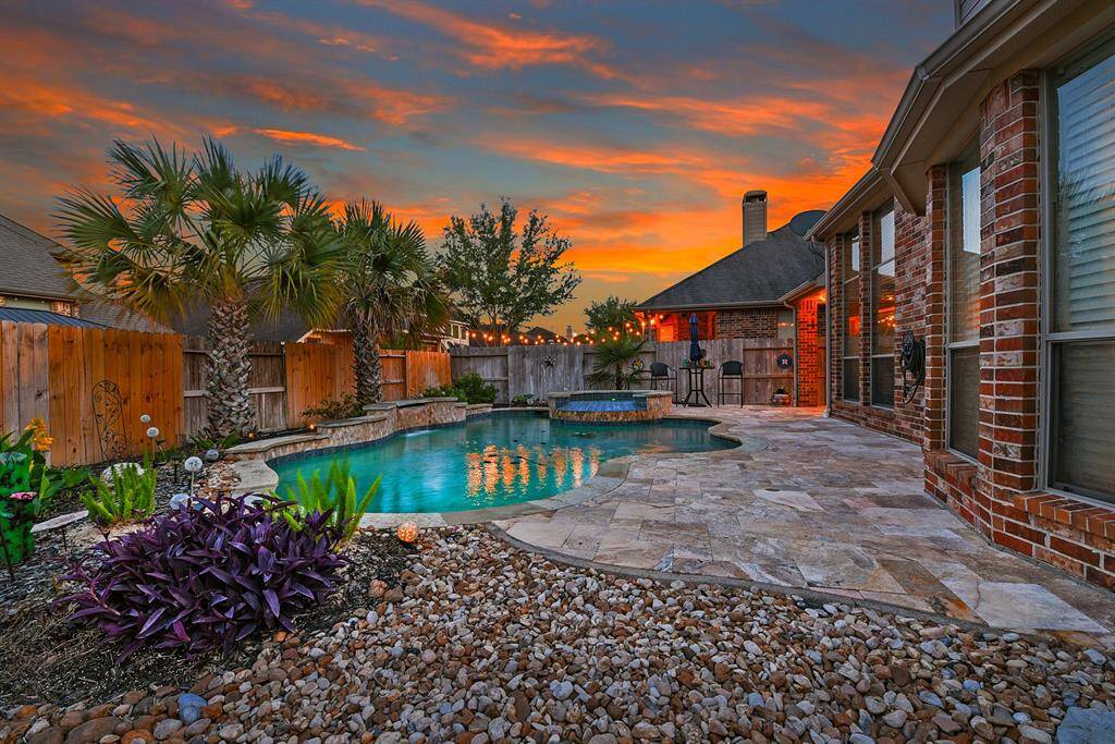 This stunning backyard perfectly combines relaxation and entertainment. Take a refreshing dip in the sparkling pool or unwind in the soothing spa—your very own private oasis. Whether you're hosting guests or enjoying a quiet evening with family, this outdoor space is made for comfort.
