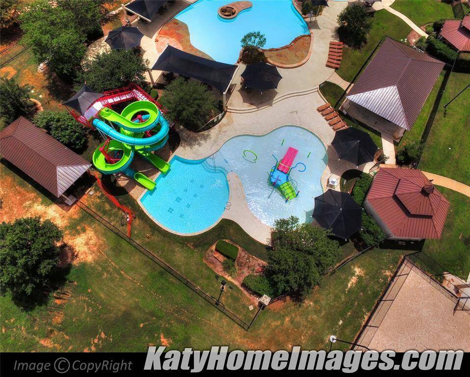 The Firethorne community pool features slides and a splash pad, conveniently located next to the park and gym, making it an amazing amenity for all family members to enjoy