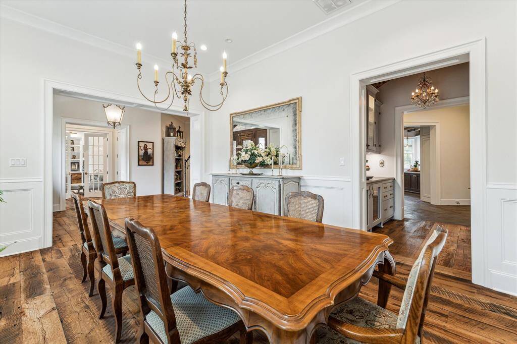 Grand dining room accommodates expansive table, along with large buffet or hutch. Note the gorgeous millwork throughout this stately room!