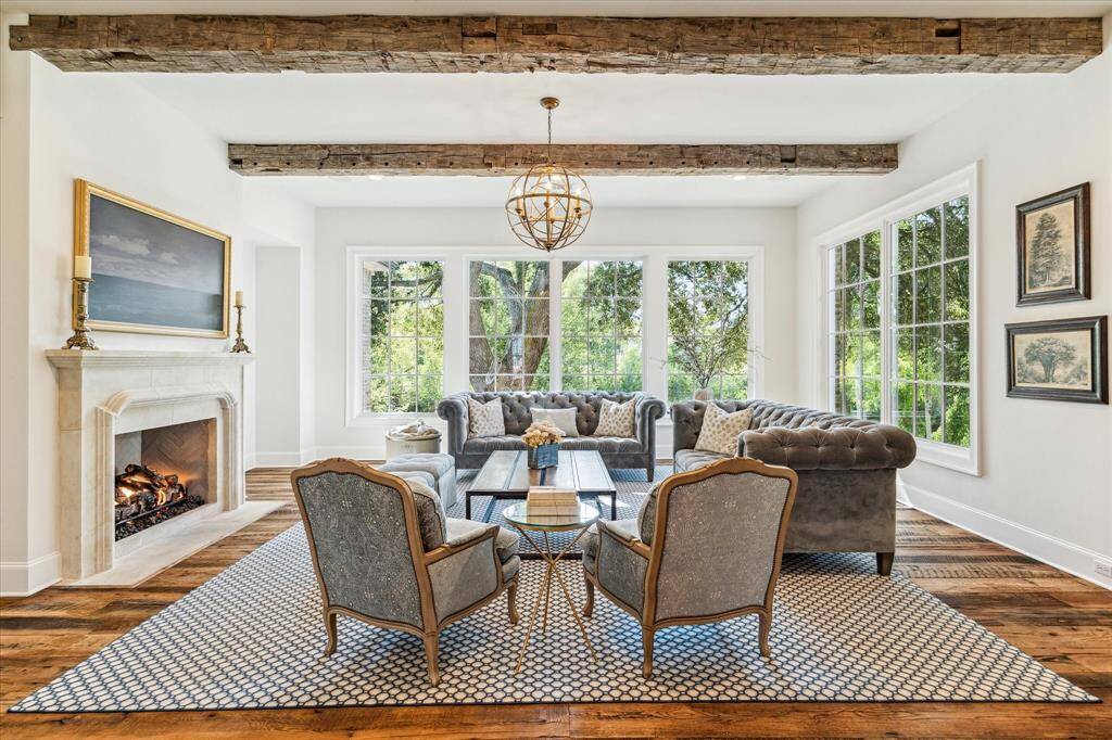 Oversize living room graced by rustic antique ceiling beams, abundant windows & stately custom fireplace. Home is perfectly situated to maximize the wonderful bayou views.