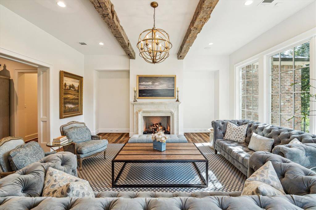 Lovely view of expansive living room, stylish fixture, recessed lighting & fabulous custom fireplace.