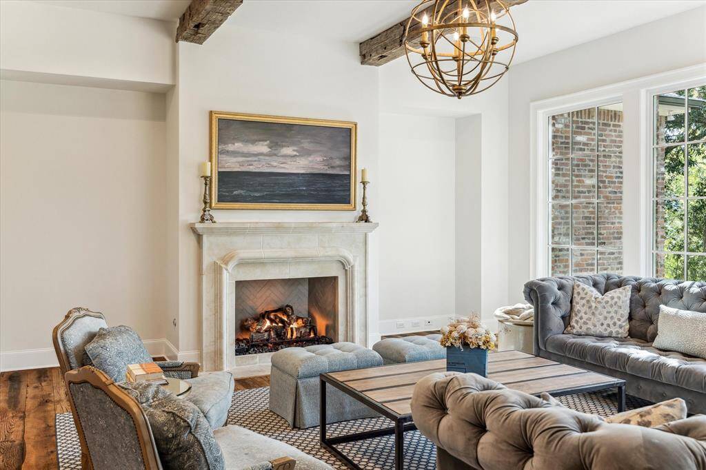 Stately Isokern gaslog fireplace boasts custom mantle & hand cut herringbone firebox.