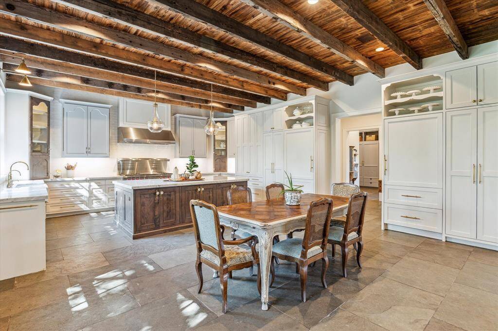 Custom cabinetry thoughtfully designed to address specific storage needs. Island boasts antique hardware imported from France, with adjacent Scotsman ice maker hidden behind custom cabinet front.