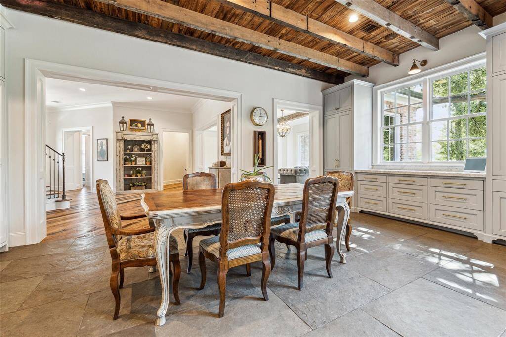 Breakfast room takes center stage of expansive open concept design, with carefully placed windows taking advantage of bayou views from every vantage point.