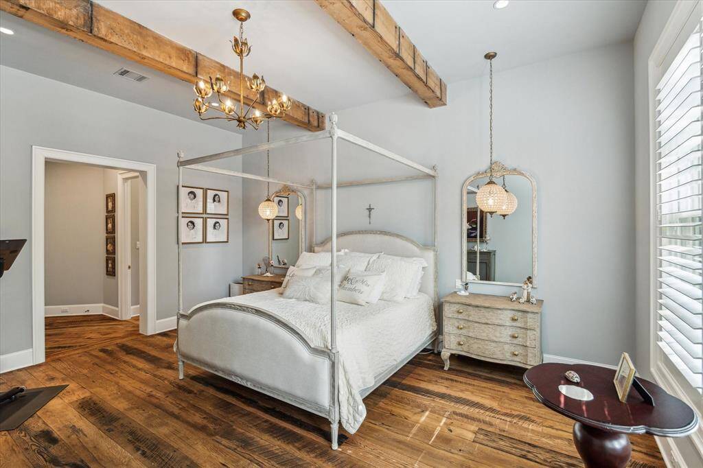 Timeless plantation shutters & antique hardwood flooring grace stunning Primary Suite, with luxurious Primary Bath just around the corner.