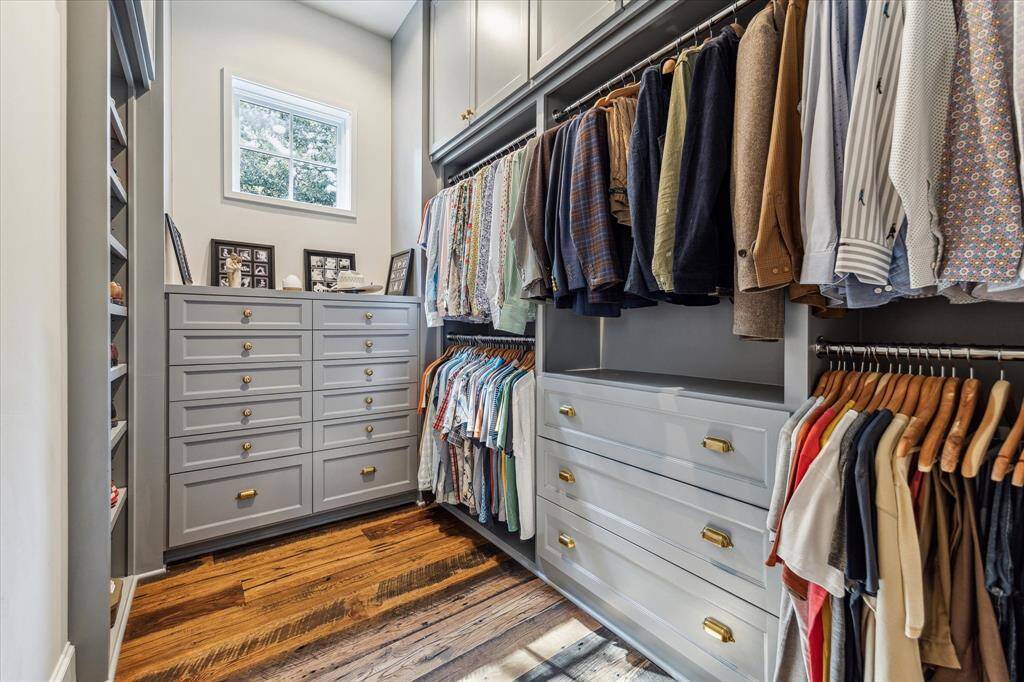 Second spacious primary closet boasts abundant hanging space & custom storage.