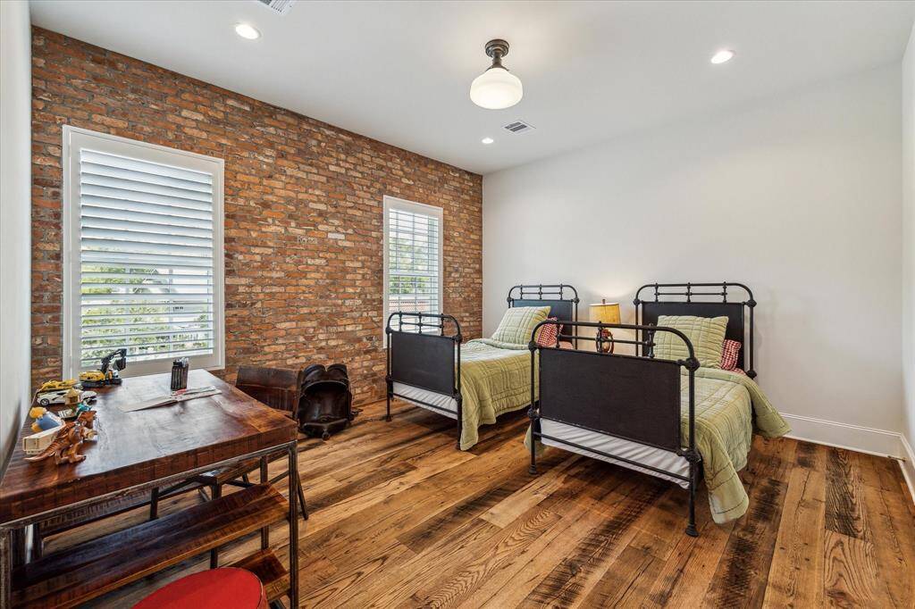 One of four spacious secondary bedrooms, all boasting the same high-end finishes as the rest of the home, with each room outfitted with private en suite bath.