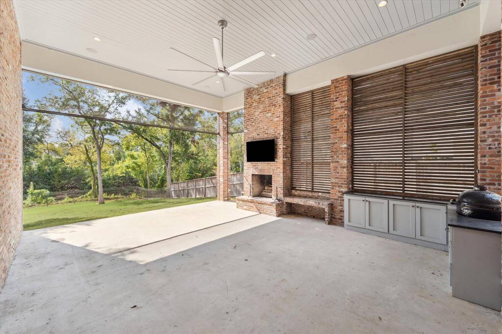 Premium Phantom retractable screens grace both ends of covered patio, keeping pests out while maintaining fabulous green views of the expansive yard!