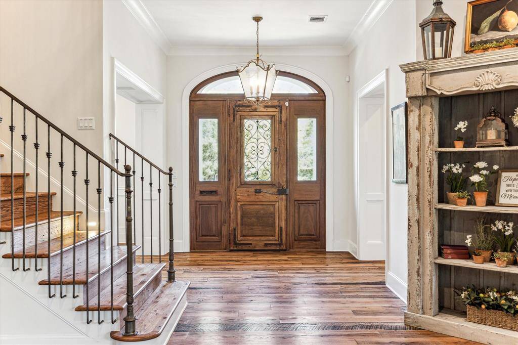 Gracious foyer boasts antique hardwood floors & soaring ceilings leading into the open living areas.