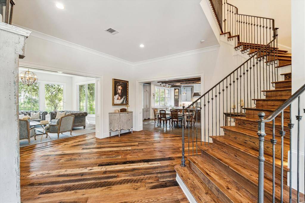 Foyer leads to open floor plan with views of living areas & kitchen. Walls of windows take full advantage of green bayou views throughout the home.
