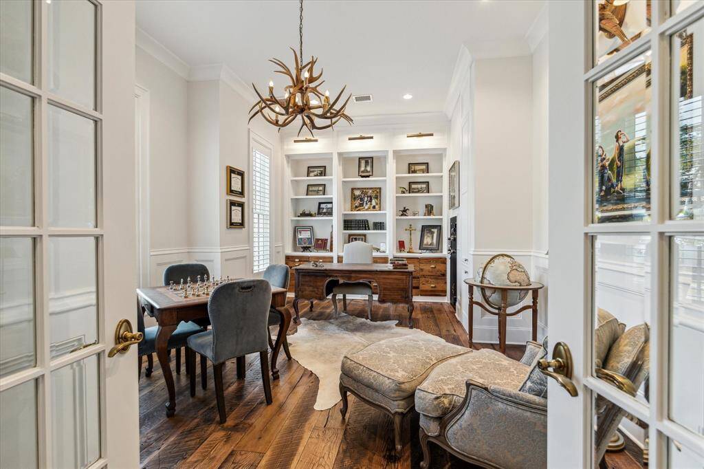 Immense private study features floor-to-ceiling built-ins with custom integrated storage drawers fashioned from reclaimed wood.