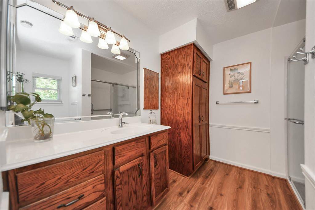 Fully updated primary ensuite boasts modern finishes, including a sleek vanity, lots of storage, and a spacious walk-in shower.