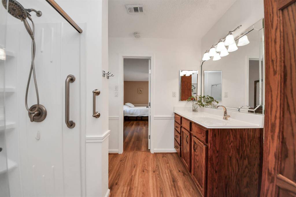 Primary ensuite bath with a spacious glass-enclosed shower.