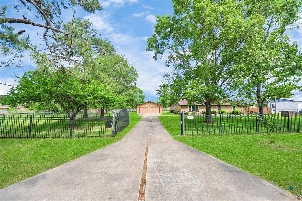 Welcome home to your beautiful oasis with a long driveway leading to a charming house surrounded by mature trees, a well-maintained lawn, enclosed by a vehicular metal electric gate/fencing, offering a serene and private country setting.