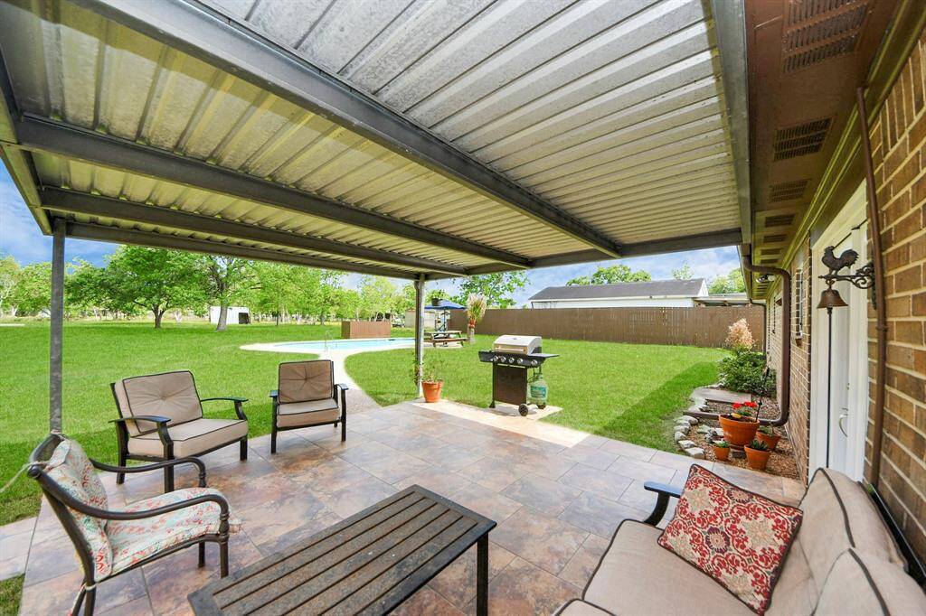 French doors lead seamlessly to the back covered patio, creating an easy flow between indoor and outdoor living, perfect for entertaining!
