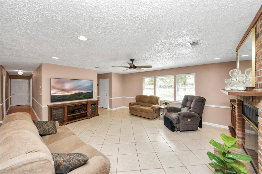 As you enter this remarkable home, you'll be greeted by an open, airy floor plan that is perfect for both intimate living and hosting family gatherings. Bright and spacious with tiled floors, and a cozy wood burning fireplace. Features ample natural light from multiple windows!
