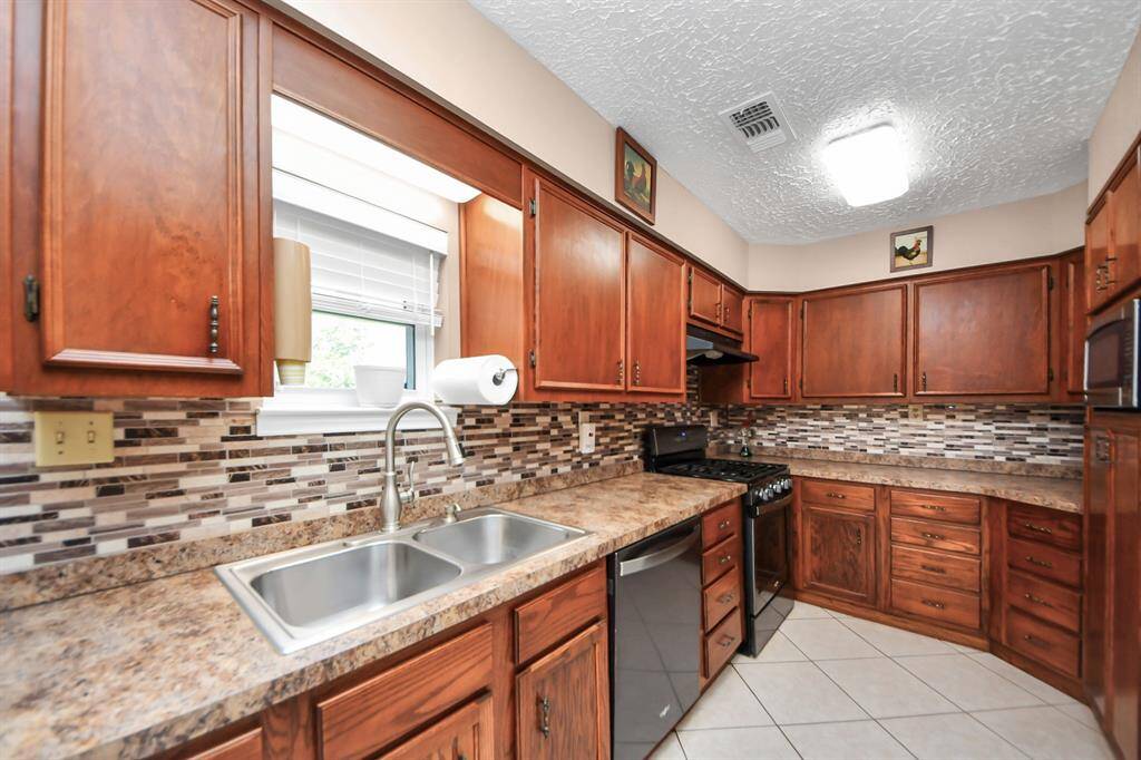Beautiful kitchen overlooking the backyard patio and pool area.