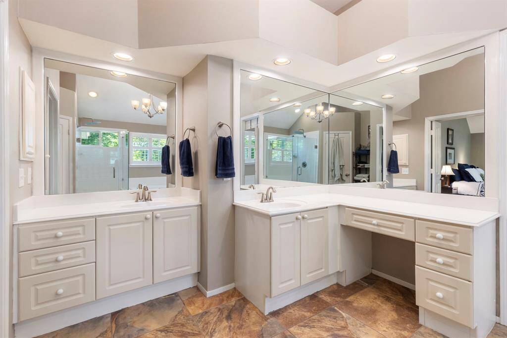 Primary bathroom with separate vanities.