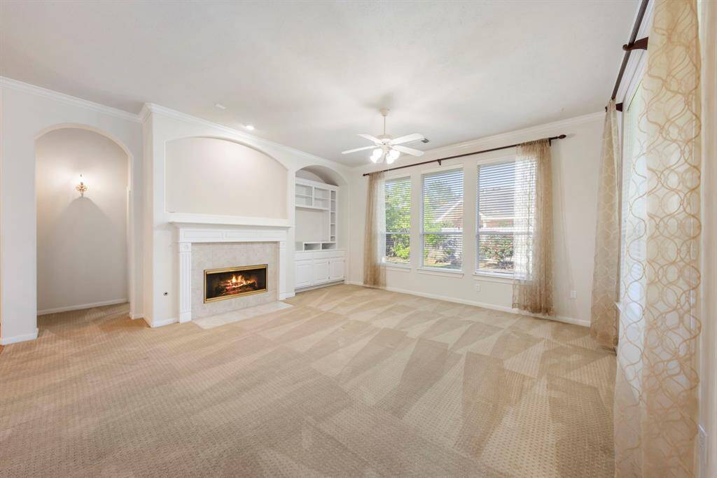 The grand, open family room features built-ins and an abundance of windows that offer beautiful views of the backyard.
