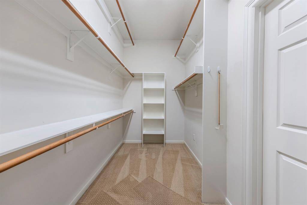 A massive walk-in closet provides ample storage space, keeping everything organized and easily accessible.