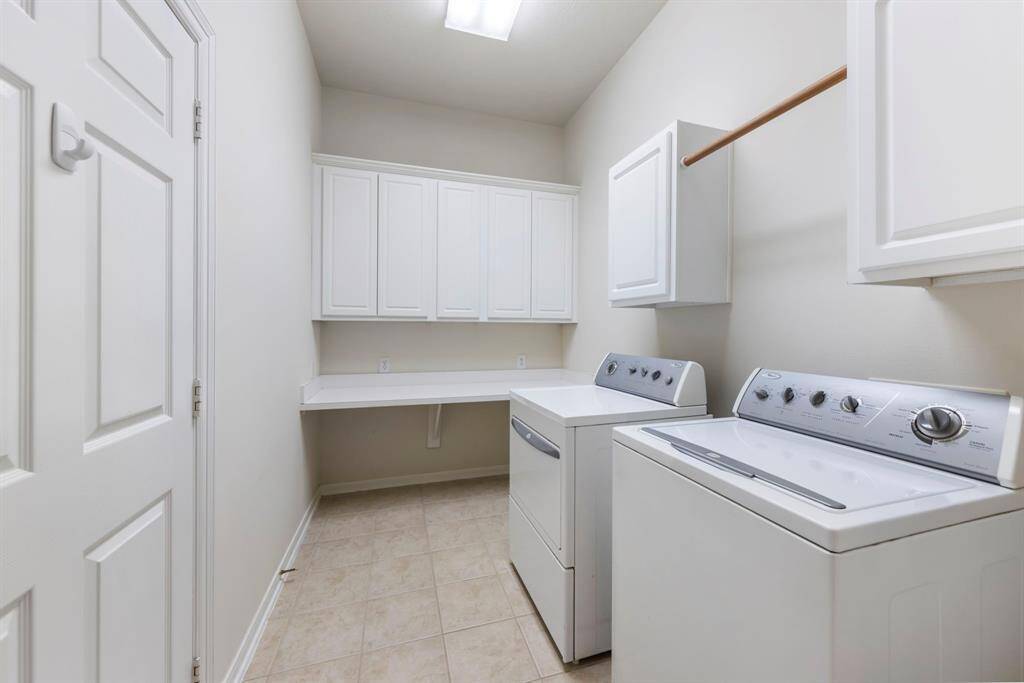 Located at the front of the home, the laundry room offers added storage and convenient access to the two-car garage.