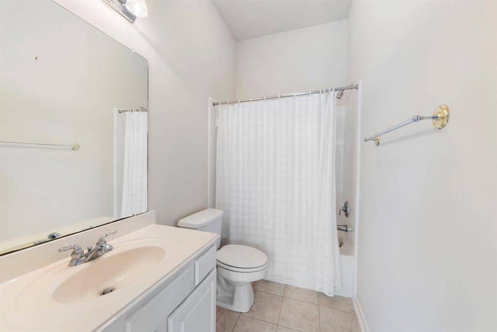 The secondary bathroom is equipped with a shower/tub combo, offering both convenience and functionality.