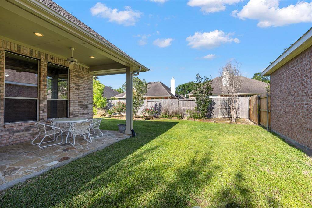 A spacious side yard offers plenty of room for pets or gardening.