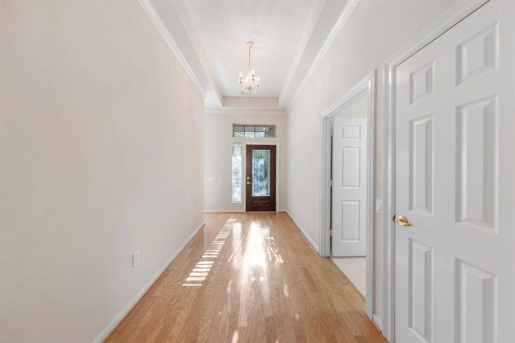 The secondary guest bedrooms are located towards the front of the home, with a utility room and coat closet conveniently situated as you enter.