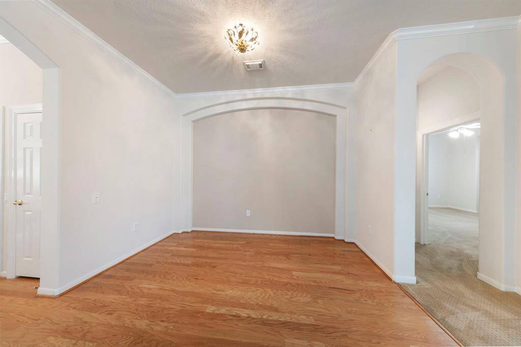 A formal dining room sits to the left, ideally positioned across from the kitchen for easy entertaining and gatherings.