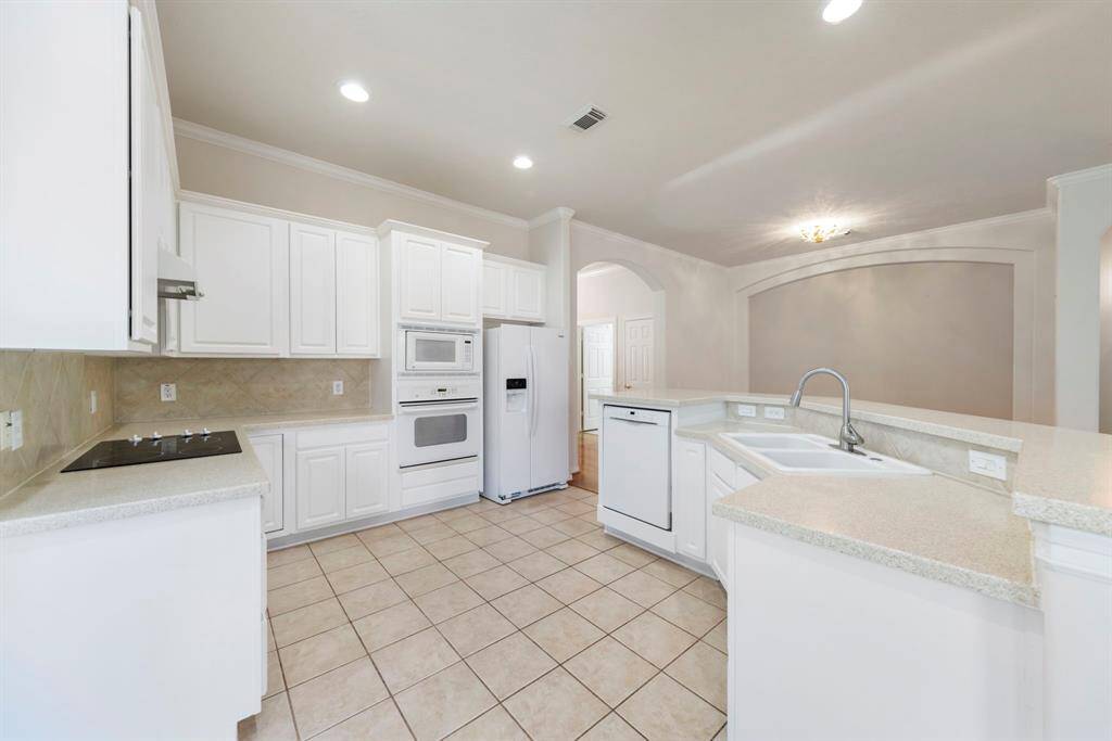 The bright, white, and spacious kitchen is ADA accessible, offering both style and thoughtful functionality.