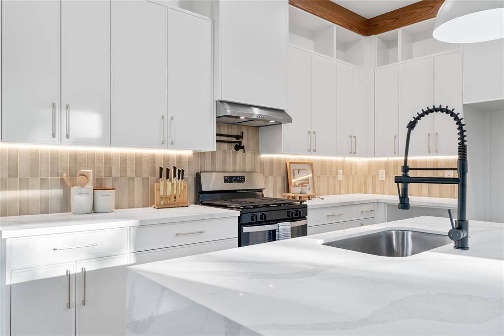 Sleek thin shaker style design in the cabinetry offers ample storage with soft-close drawers and stylish hardware.