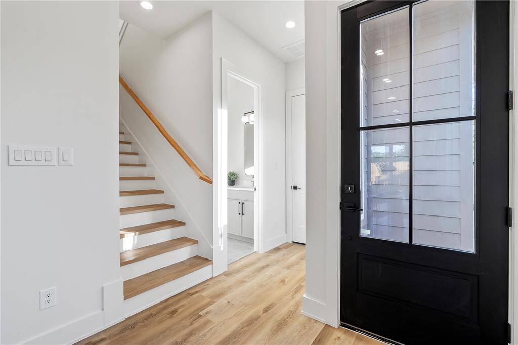A sleek and space-efficient half bath conveniently tucked under the staircase, featuring modern finishes and designer touches.