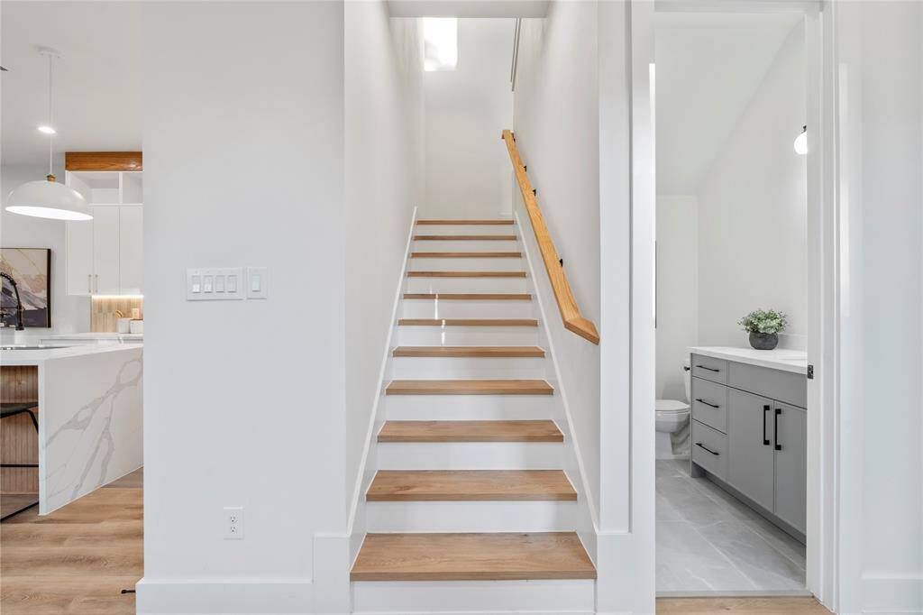 Tucked discreetly near the entrance, the staircase leads you to second-floor living, creating a sense of separation and flow throughout the home