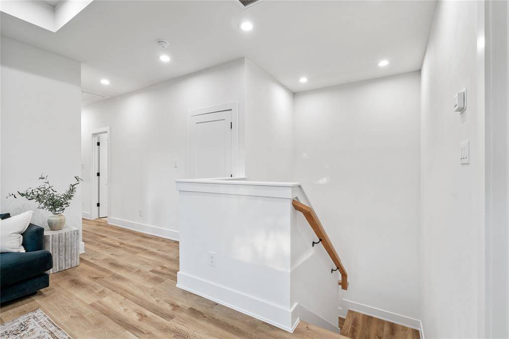 This flex space features high ceilings, large windows for natural light, and LVP flooring for a cozy yet sophisticated feel.