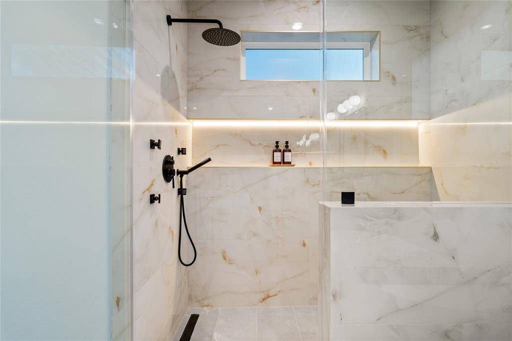 The oversized shampoo niche in the primary ensuite now features sleek LED lighting, adding both function and a spa-inspired glow.
