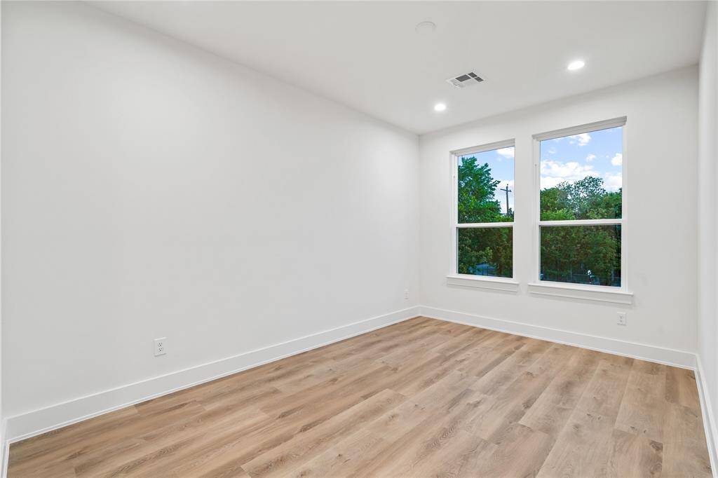Well-appointed secondary bedrooms with high ceilings, large windows, and walk-in closets.