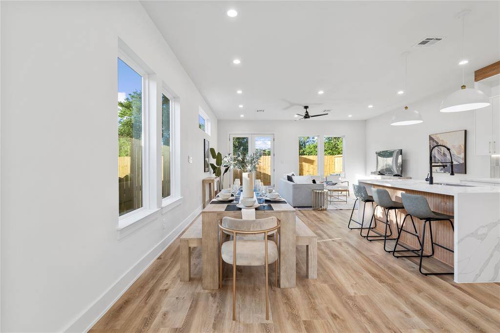 A welcoming entryway featuring a modern wood and glass front door, allowing natural light to stream into the home.