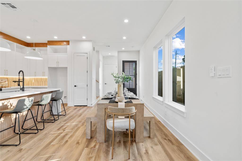 An elegant dining space positioned between the kitchen and living area, with ample space for a large table.