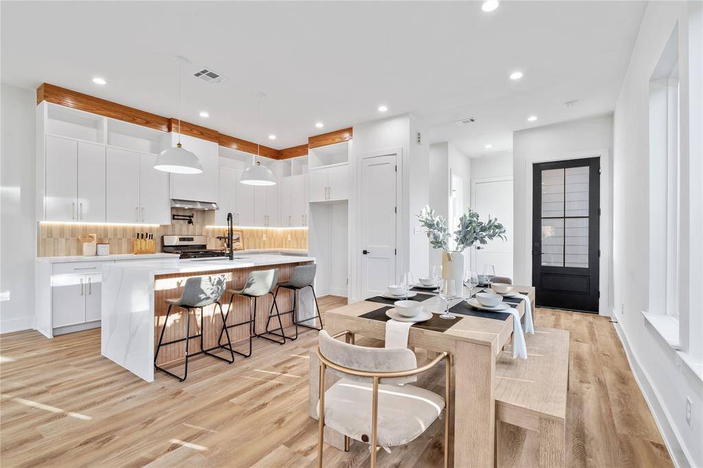 A bright, airy living room featuring high ceilings, large windows for natural light, and elegant lighting.