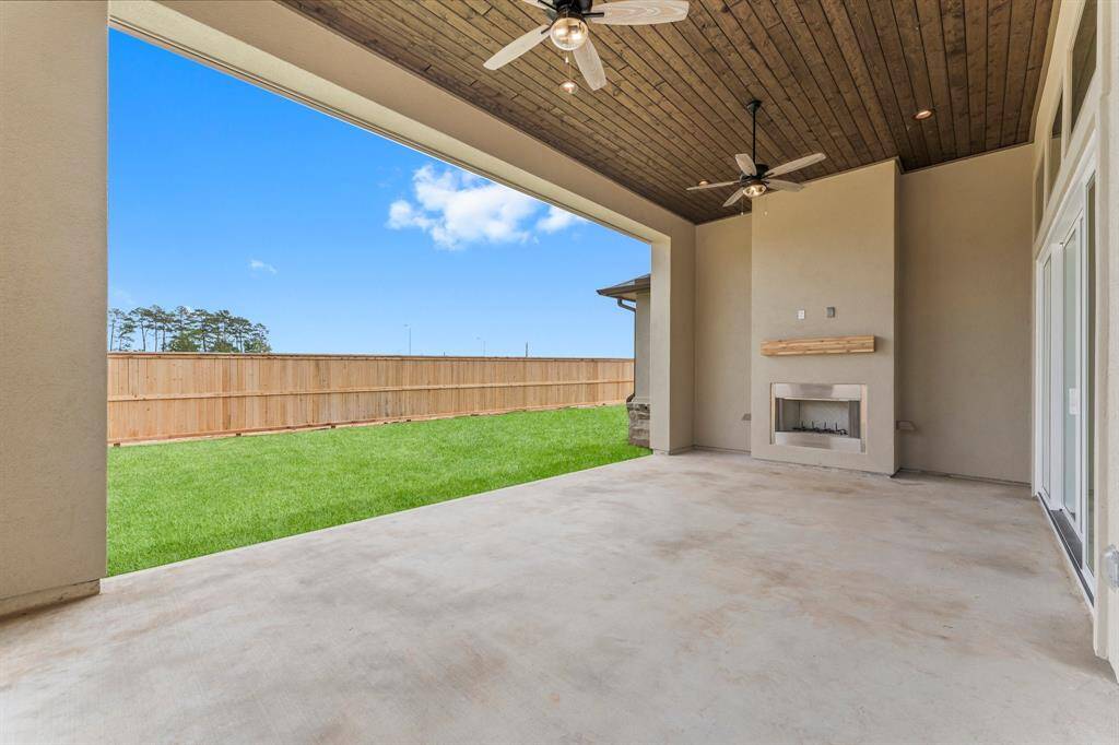Enjoy Your Back Yard Year Round with the Wood Burning Fireplace and Fans