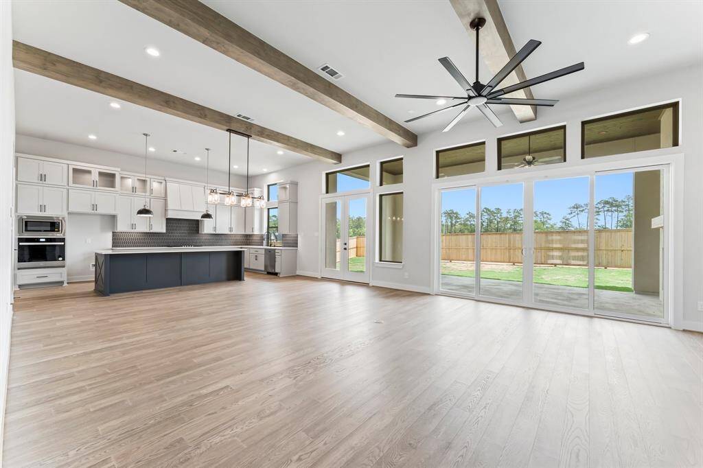 Slider Doors to the Covered Rear Patio and Beams at the Great Room and Dining